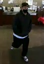 The subject is described as a Caucasian or Hispanic male adult who stands approximately 5’8” with a medium build and dark hair. At the time of the robbery, the subject had a goatee and wore a black baseball cap, black hooded sweatshirt, white undershirt, black pants, and Converse-style black and white tennis shoes.
